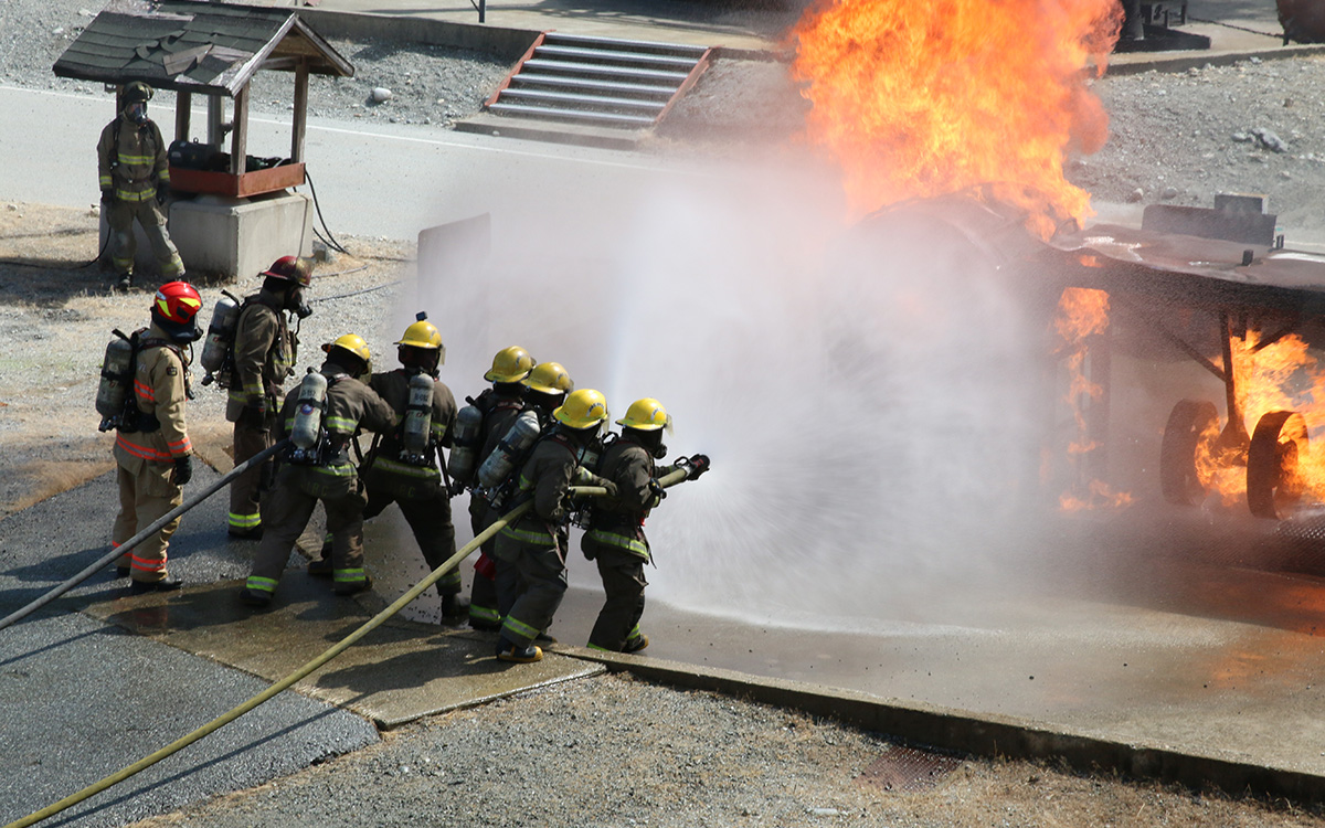 A recent cohort of the Fire Fighting Technologies Certificate program, fully funded through federal and provincial grants, performs a live-fire training exercise at JIBC's Maple Ridge campus. 