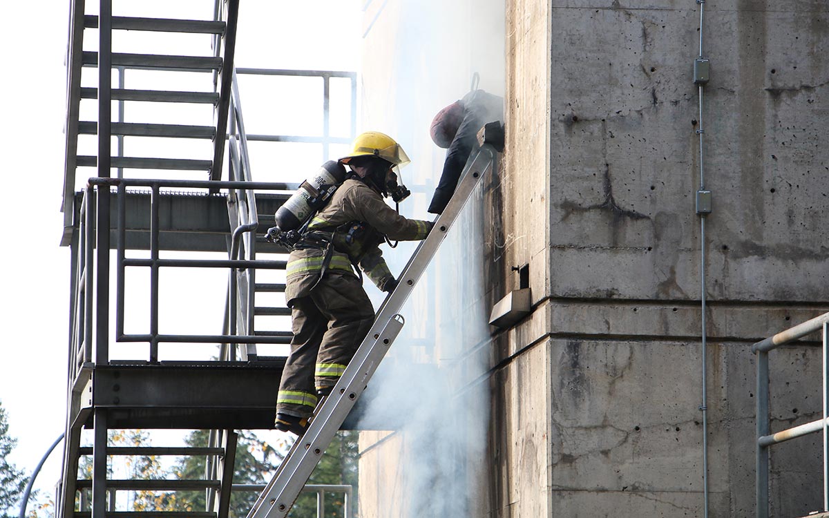 FFTC grad Yousif Safar demonstrates a ladder rescue at JIBC’s Maple Ridge campus.