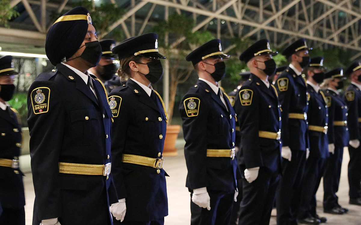 B.C. sheriff recruits stand at attention during their graduation from the JIBC Sheriff Academy in a ceremony held at the courthouse in Vancouver. 