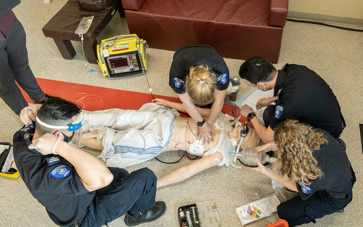 Advanced Care Paramedic students practise their training on mannequin.