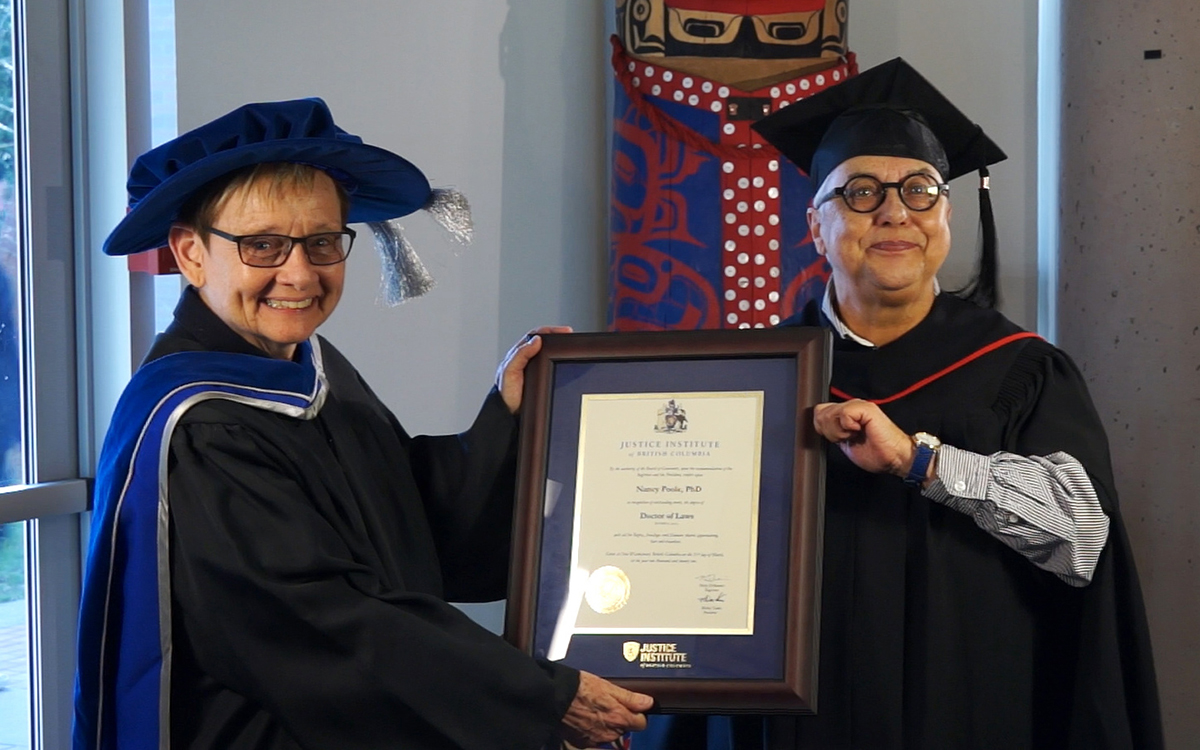 Dr. Nancy Poole is conferred her JIBC honorary degree with the help of life partner Jan Trainor. 