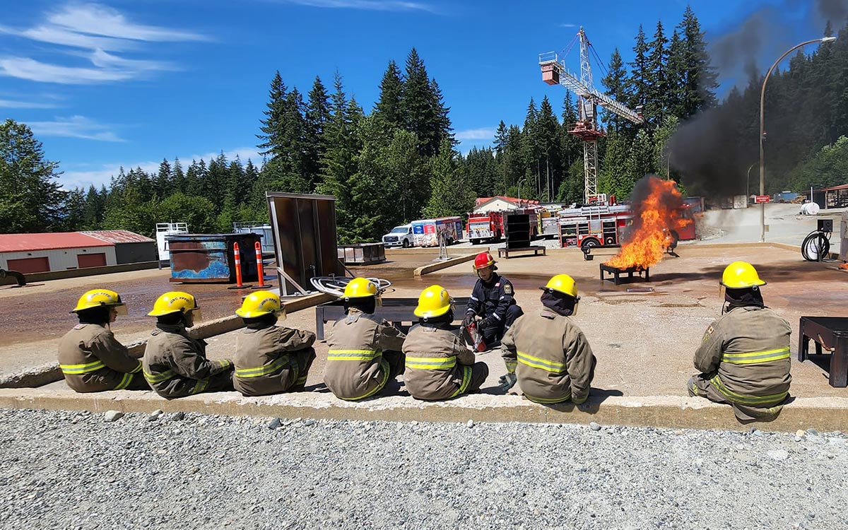 An instructor from JIBC's Fire & Safety Division gives a lesson at the Maple Ridge campus on using a fire extinguisher to participants of the Indigenous Youth Career Camp.