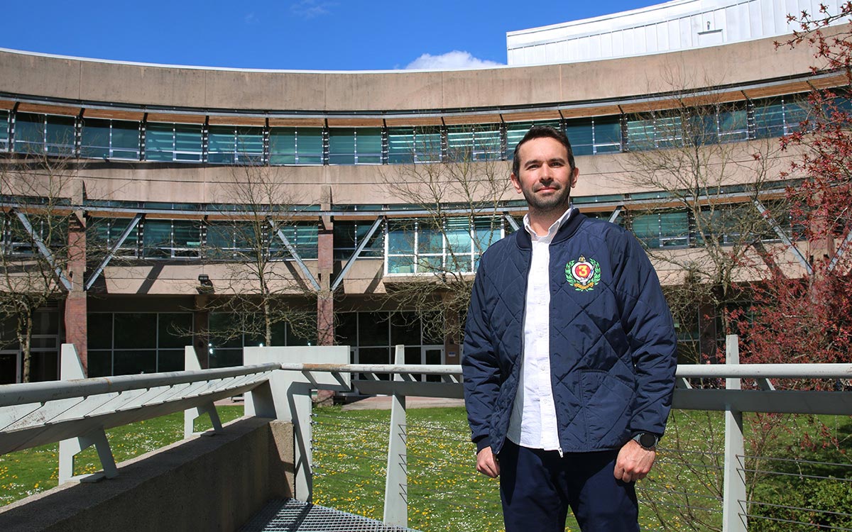 Rodrigo Miyake stands overlooking the courtyard of JIBC's New Westminster campus.