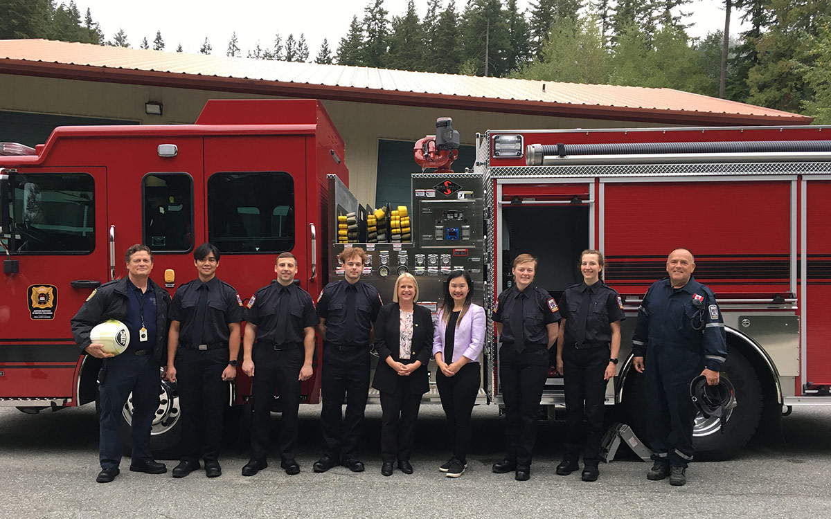 Minister Anne Kang and Maple Ridge-Pitt Meadows MLA Lisa Beare pose with firefighting instructors and students with new fire truck at Maple Ridge campus.