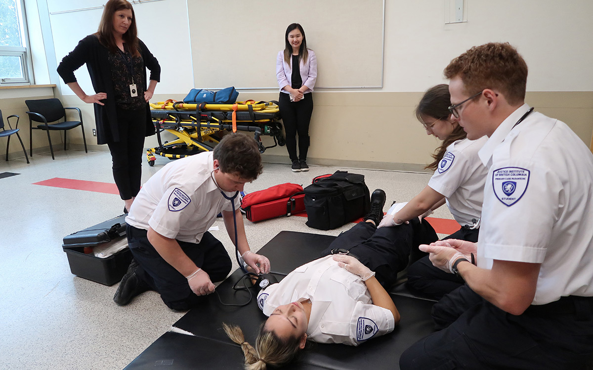 Minister Anne Kang observes paramedic scenario training at New Westminster campus.