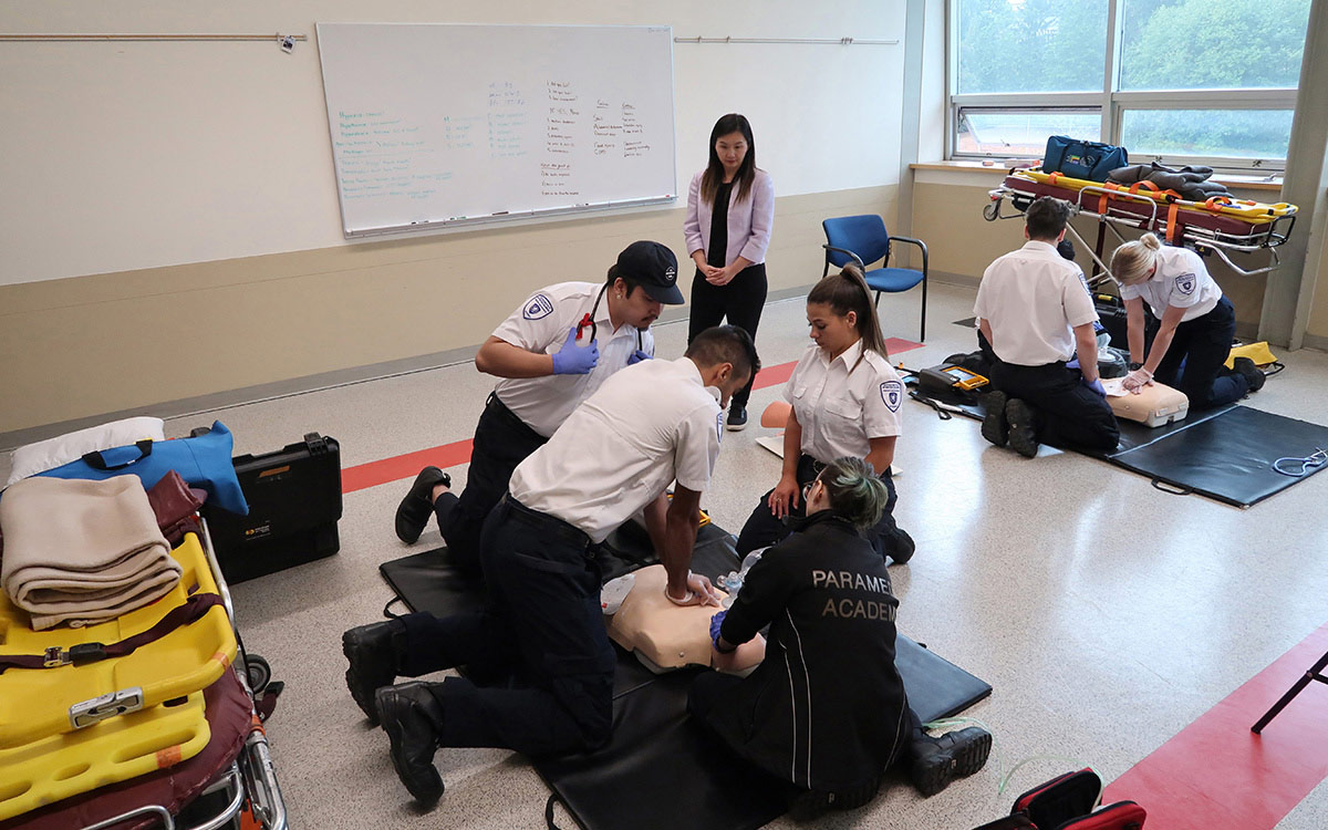 Minister Anne Kang observes paramedic scenario training at the New Westminster campus.