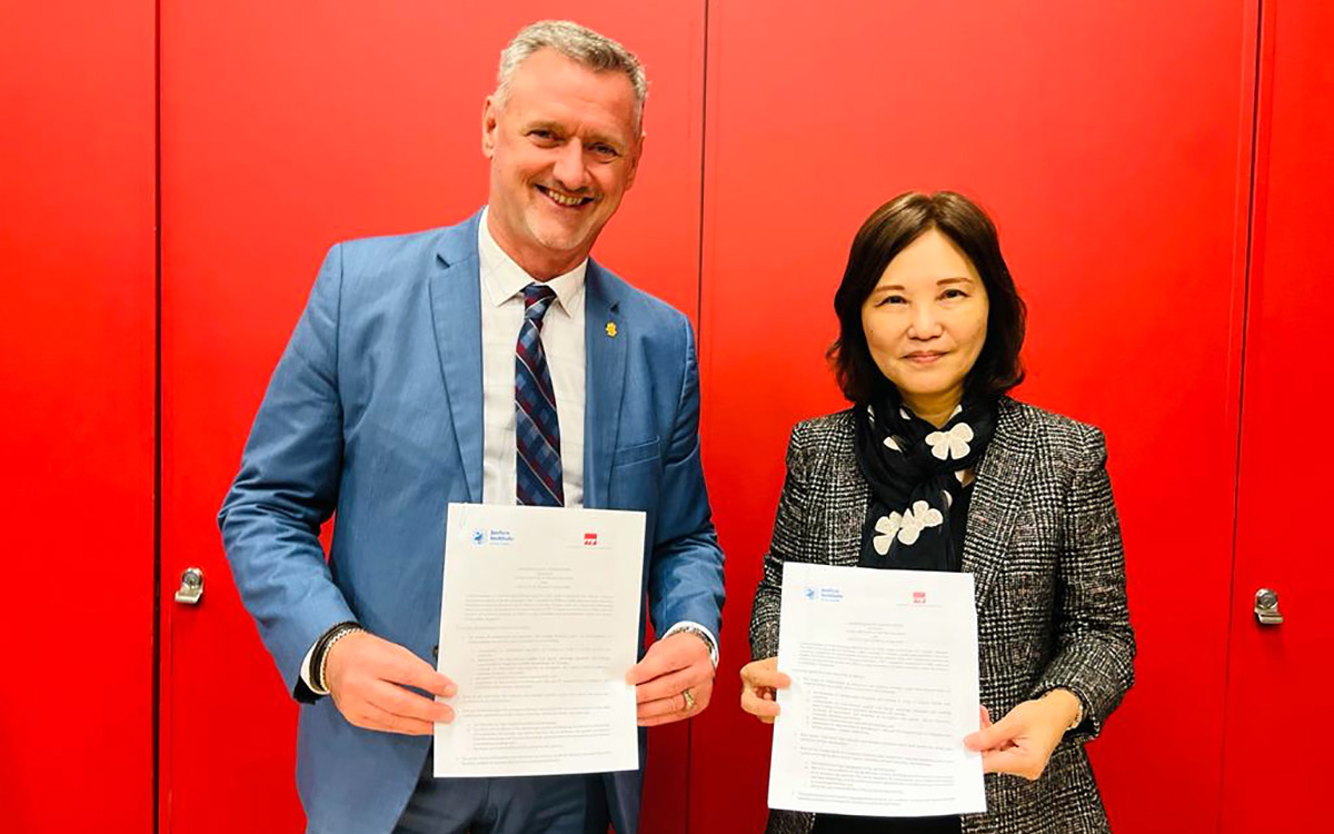 JIBC President and CEO Michel Tarko and Low Khah Gek, CEO of the Institute of Technical Education (ITE) in Singapore holding up the signed MOU documents.