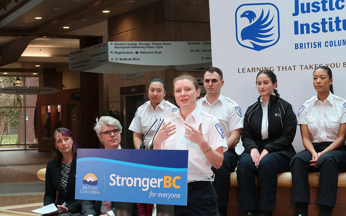 Primary Care Paramedic student Kate Peer speaks at podium during funding announcement at JIBC.