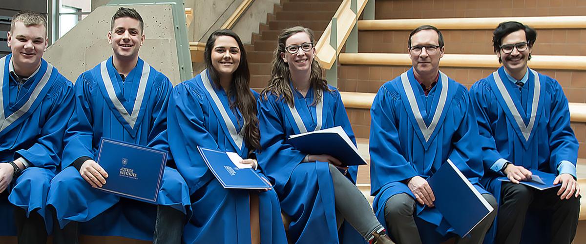 JIBC Grads posing in the atrium