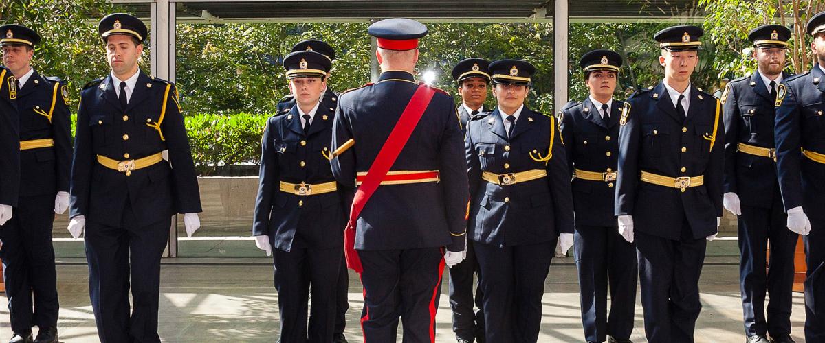 Graduating class of sheriff recruits stand at attention at ceremony at Vancouver Law Courts on June 30, 2022. 