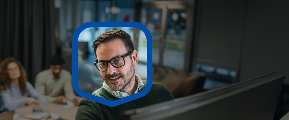 Man with glasses leading a meeting.