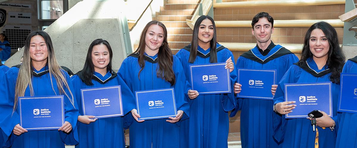 JIBC Grads posing in the atrium