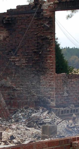 Girl standing in front of a brick house