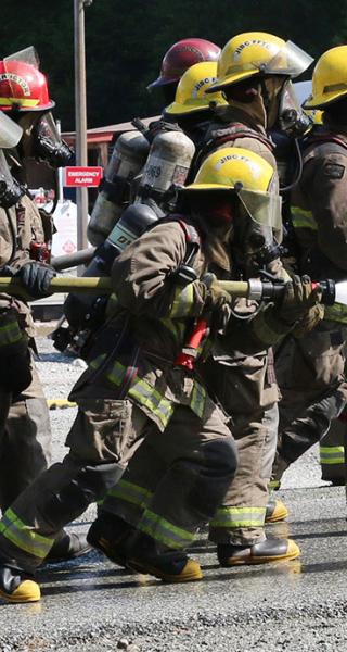 JIBC firefighting students perform live-fire training exercise.