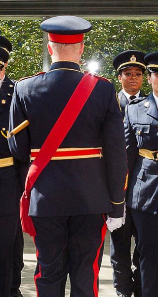 Graduating class of sheriff recruits stand at attention at ceremony at Vancouver Law Courts on June 30, 2022. 