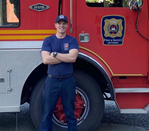 FFTC grad Jesse Fryer in front of fire truck at JIBC Maple Ridge campus.