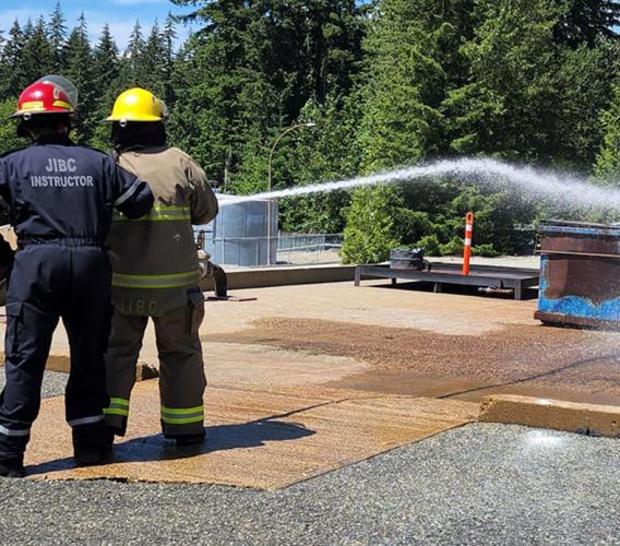 Participants in Indigenous Youth Career Camp at JIBC learn to use a fire hose at the Maple Ridge campus.