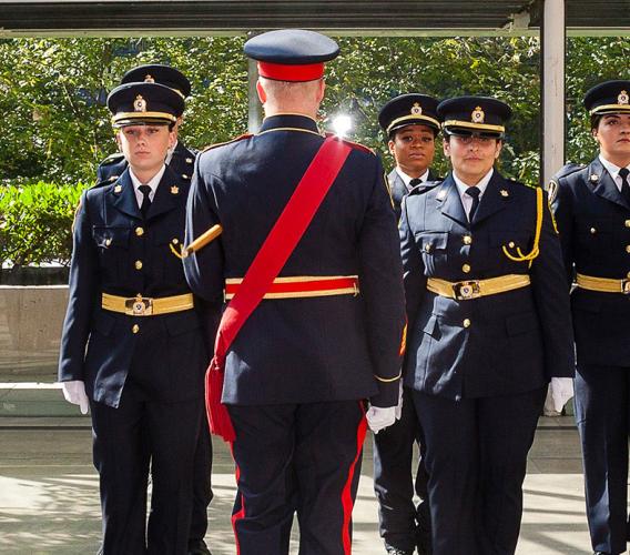 Graduating class of sheriff recruits stand at attention at ceremony at Vancouver Law Courts on June 30, 2022. 