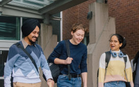 A group of students standing in front of a JIBC campus building.