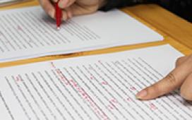 person writing on a sheet of paper