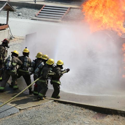 A recent cohort of the Fire Fighting Technologies Certificate program, fully funded through federal and provincial grants, performs a live-fire training exercise at JIBC's Maple Ridge campus. 