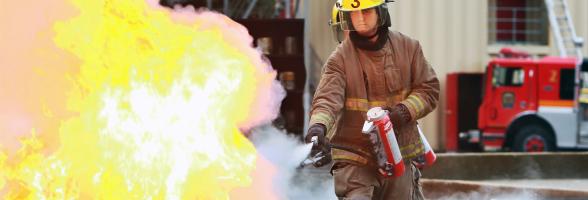 A firefighter putting out a fire