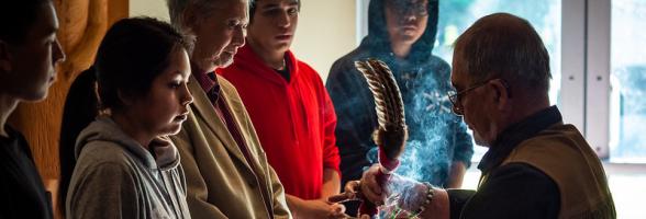 A group of people participating in an indigenous ceremony