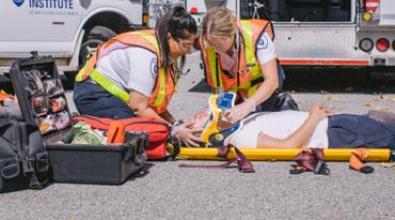 Paramedics helping injured person on a stretcher