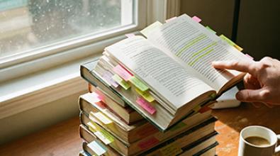 a stack of books by window