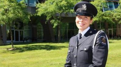 A police officer posing on a field