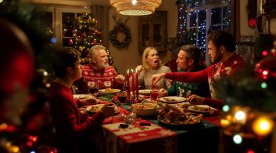 People argue around festive Christmas dinner table.