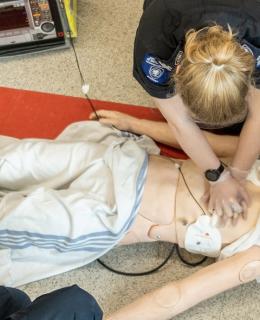 Overhead shot of Advanced Care Paramedic students practising CPR on a mannikin.