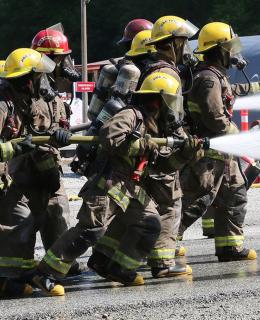 JIBC firefighting students perform live-fire training exercise.