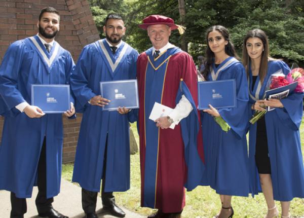 JIBC grads with JIBC President Michel Tarko