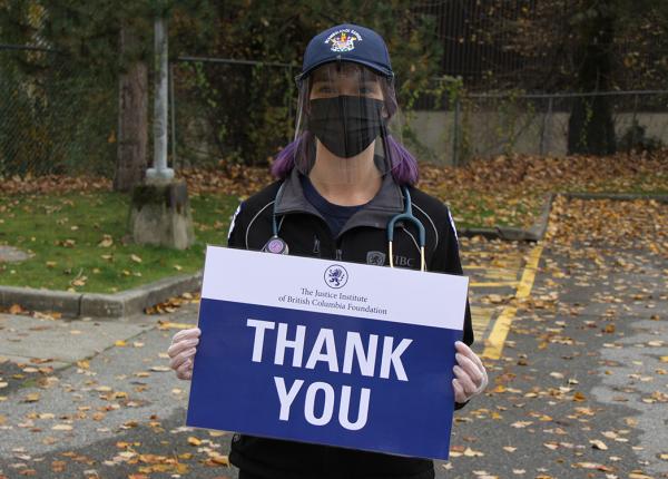 JIBC students holds up sign thanking donors to The JIBC Foundation.