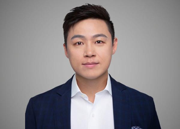 Man wearing dark blazer and white shirt.